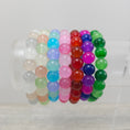 Load image into Gallery viewer, Glass bead stretch bracelets on stand.
