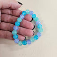Load image into Gallery viewer, Blue, purple and green glass ball bead stretch bracelet.