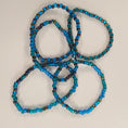 Load image into Gallery viewer, Blue, green and rainbow colored beaded bracelets.