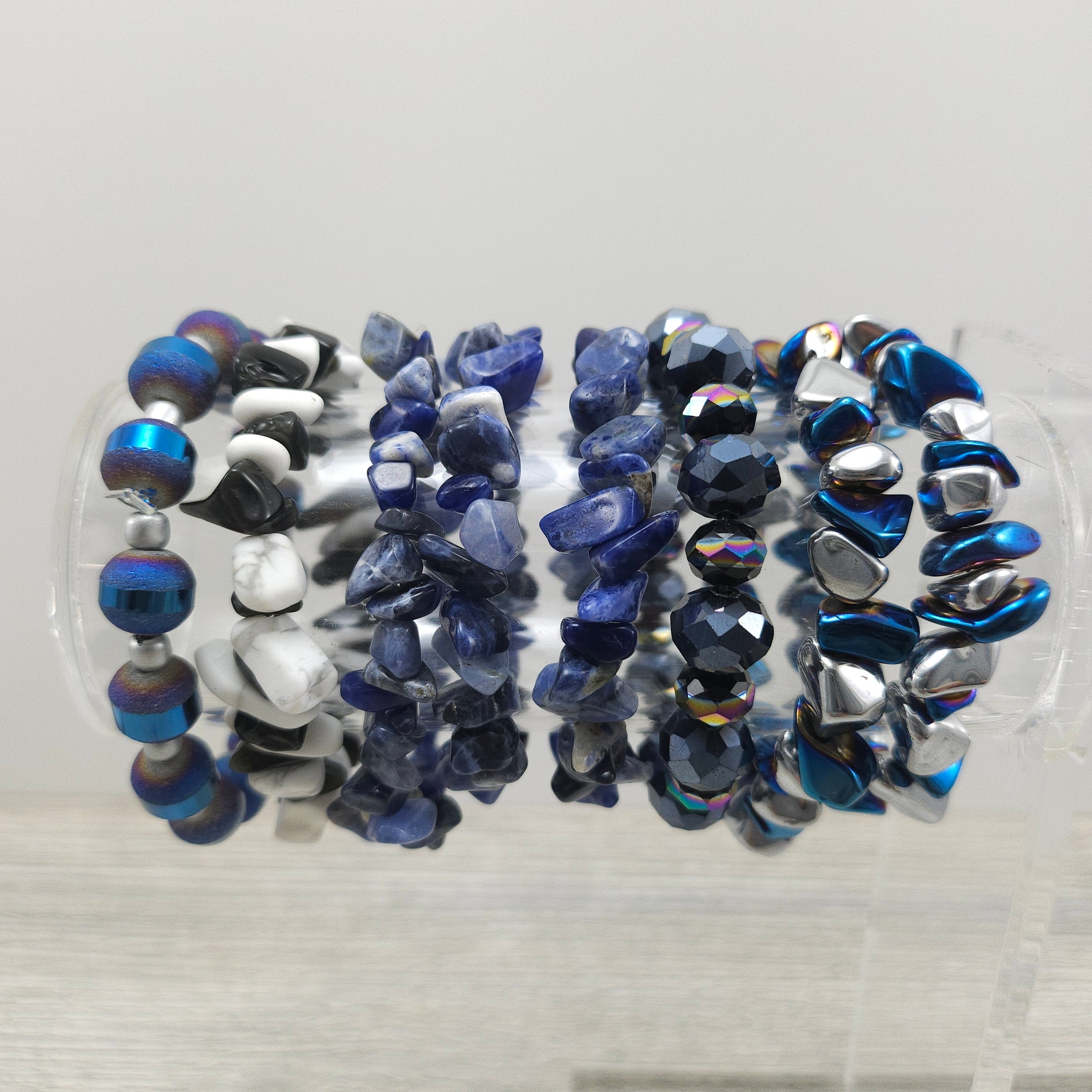 Rock stretch bracelets on stand.