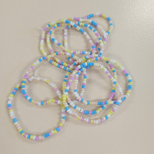 Blue, purple, white, yellow and pink beaded friendship bracelet.