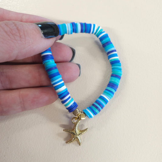 Blue stretch bracelet with gold starfish charm.