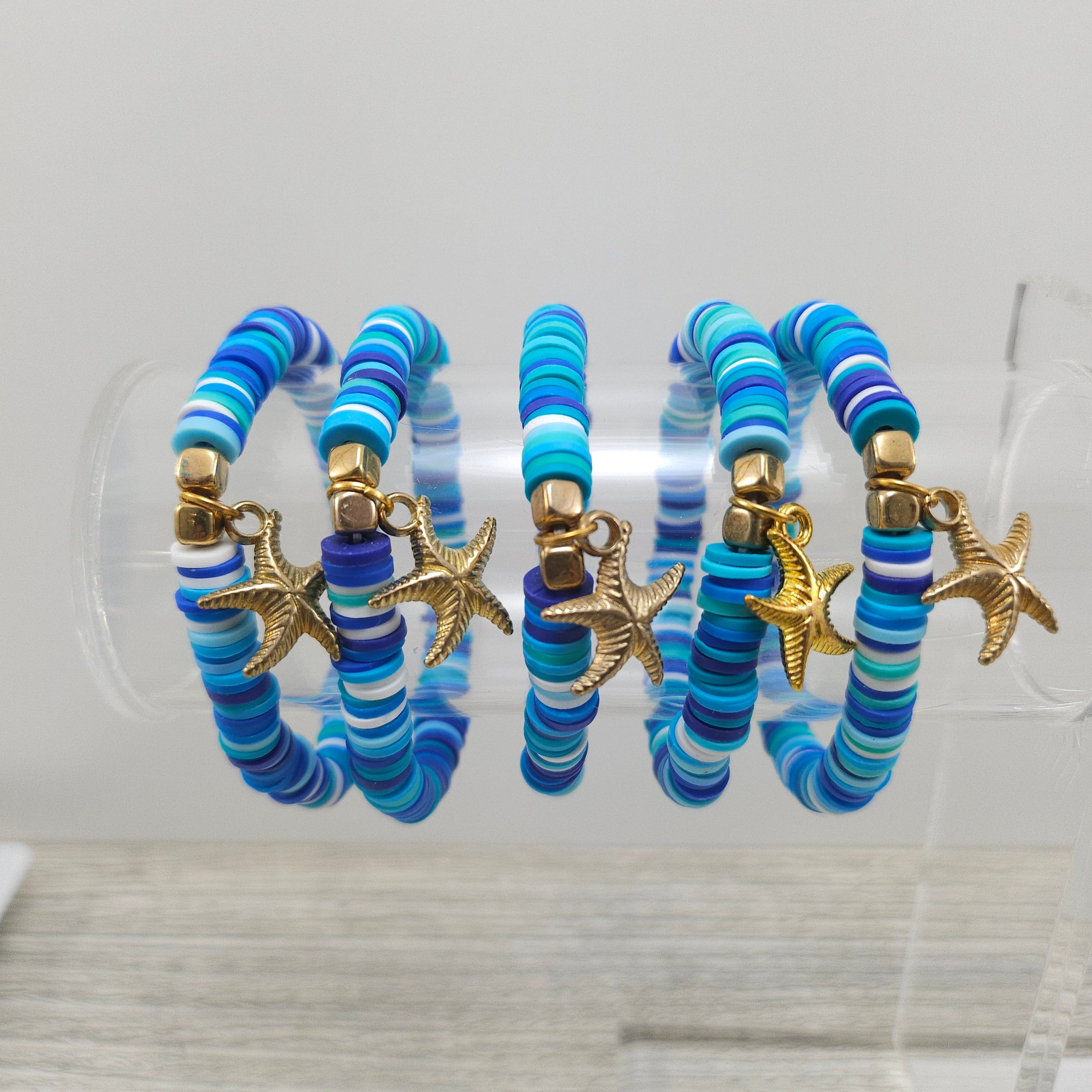 Ocean themed stretch friendship bracelets with gold starfish charm.