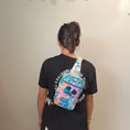 Load image into Gallery viewer, Person wearing a black shirt with a colorful patterned bag over their shoulder against a plain background