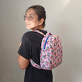 Load image into Gallery viewer, A person wearing the grogu inspired pink backpack.