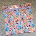 Load image into Gallery viewer, Colorful Disney-themed folder with character patterns on a gray surface