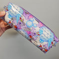 Load image into Gallery viewer, Pouch with cartoon character design held by a hand against a gray background