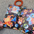 Load image into Gallery viewer, Colorful keychain with cartoon characters on a textured surface