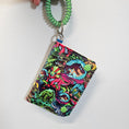 Load image into Gallery viewer, Colorful keychain with dinosaur design on a white background