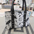Load image into Gallery viewer, Tote bag with black and white pattern on a checkered floor