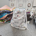 Load image into Gallery viewer, Lots of drawstring bags on a wool surface.