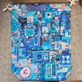 Load image into Gallery viewer, Blue themed drawstring bag on a gray surface.