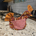 Load image into Gallery viewer, Decorative oven mitt with floral patterns on a kitchen counter.