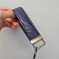 Load image into Gallery viewer, Blue and black cork key fob with metal hardware.