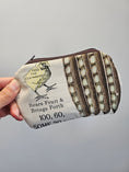 Load image into Gallery viewer, A hand holding a small zippered pouch with a vintage-style egg carton print. The pouch features a cream background with brown egg carton rows, black text reading 'Bears Fruit & Brings Forth 100, 60, SOME 30', and a yellow chick illustration with the words 'FEED THE EGG MAKER'.