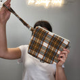 Load image into Gallery viewer, Orange and brown flannel wristlet purse.