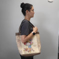 Load image into Gallery viewer, Vintage flower seed tote bag worn on the shoulder.