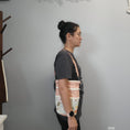 Load image into Gallery viewer, Floral llama purse being worn on a shoulder.