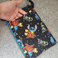 Load image into Gallery viewer, Beyond cool stitch in space cell phone bag with exterior slip pocket.