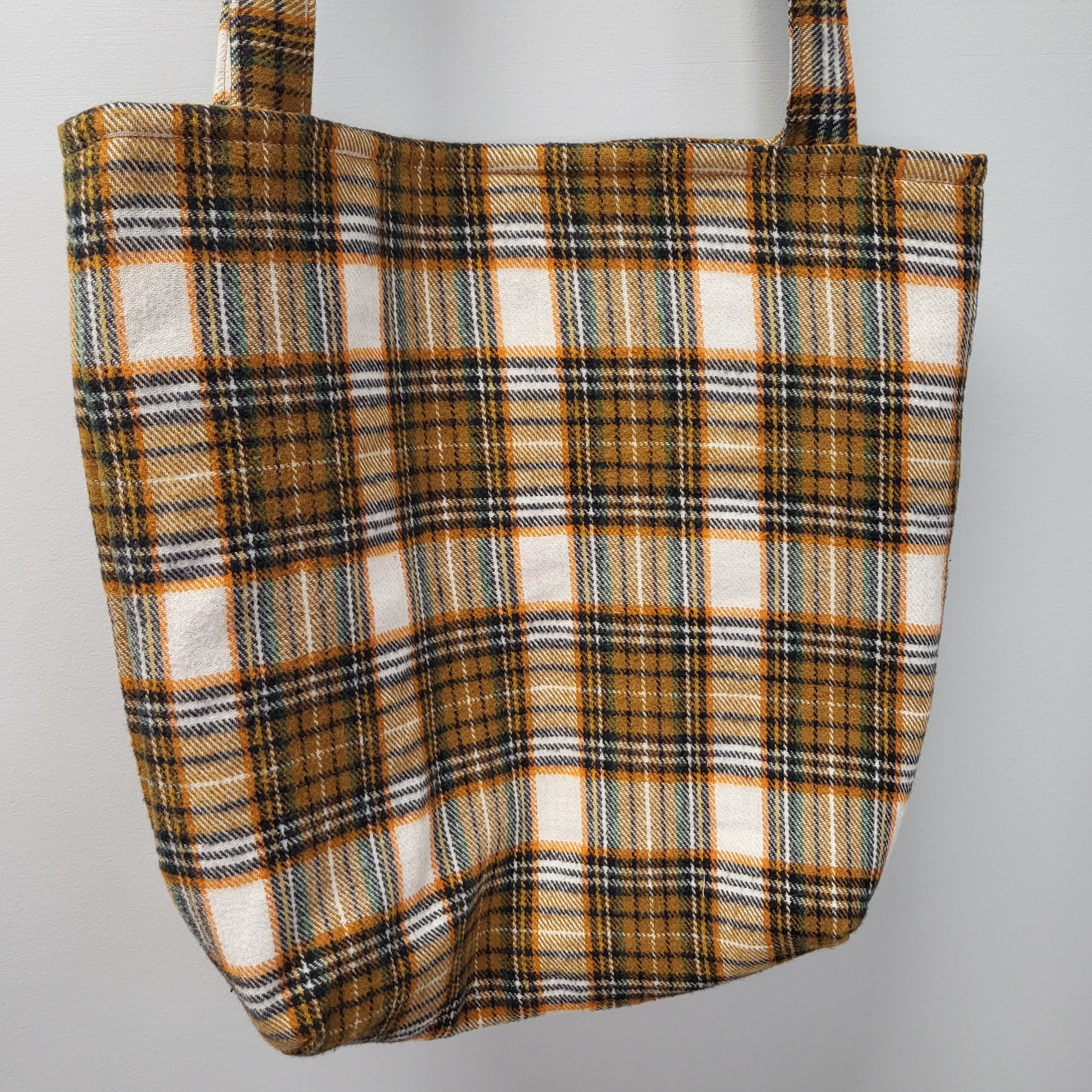 Orange, black and green plaid flannel tote bag.