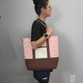 Load image into Gallery viewer, Person wearing the cherry blossom tote bag on their shoulder.