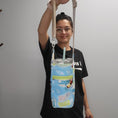 Load image into Gallery viewer, Person holding the surfing mickey drink carrier bag with a drink in it.