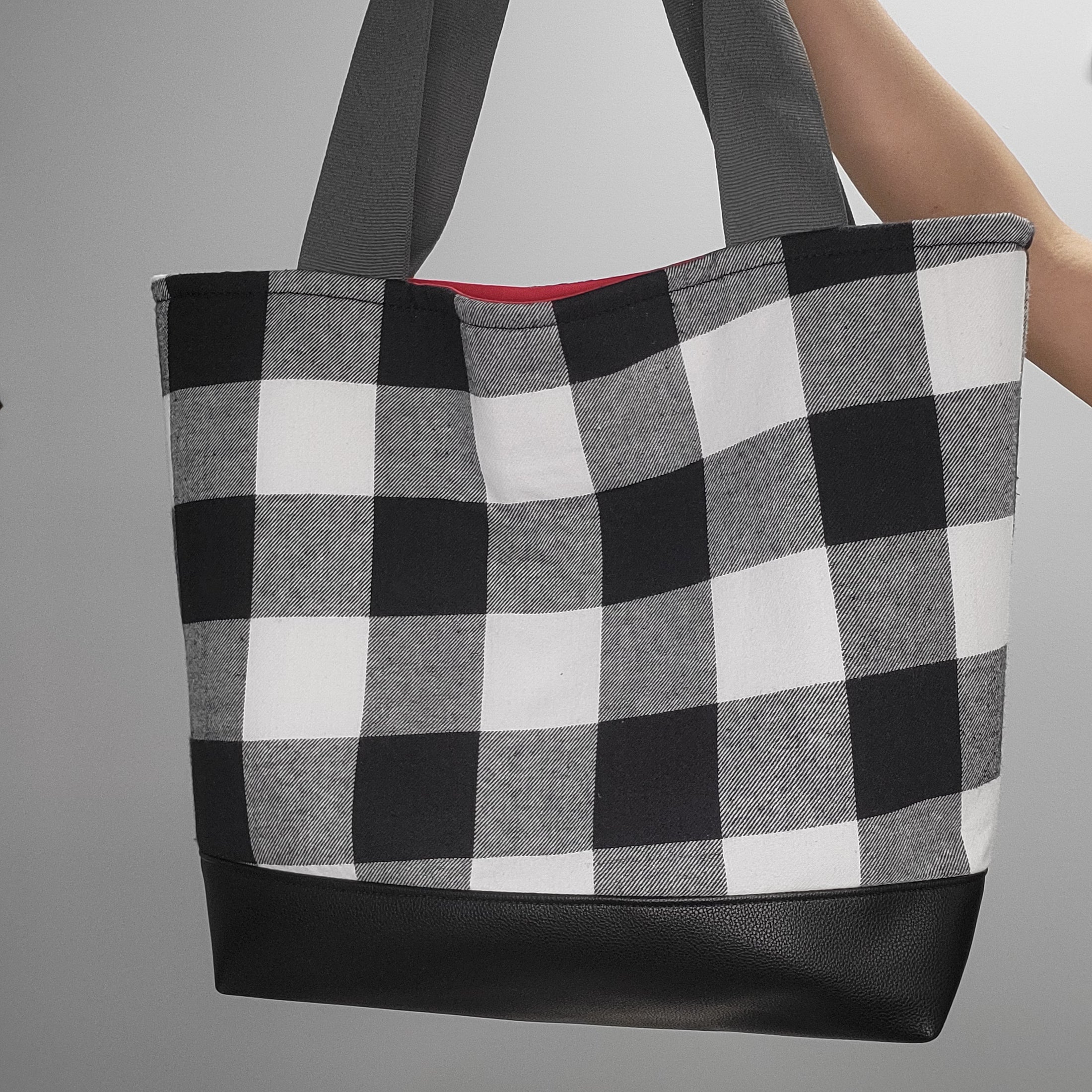Black and white flannel tote bag with vegan leather black bottom.