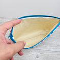 Load image into Gallery viewer, Cream interior of paw prints cosmetic pouch.