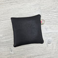 Load image into Gallery viewer, Black back of the mini spring flowers zipper pouch.