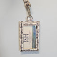 Load image into Gallery viewer, Floral skull id holder with clear glitter pocket.