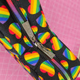 Load image into Gallery viewer, Pouch with rainbow heart pattern on a pink grid background