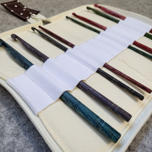 Crochet hook organizer case filled with wood crochet hooks.