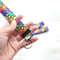 Load image into Gallery viewer, Rainbow puzzle pieces key fob with gunmetal hardware.