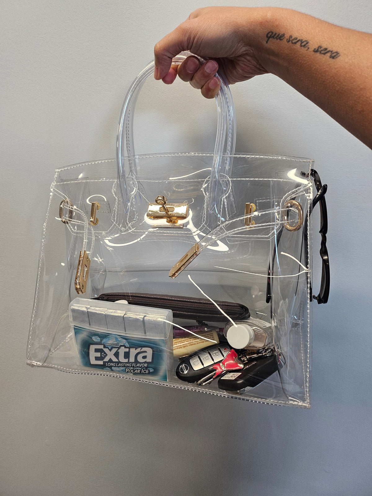 Clear graduation ceremony bag filled with personal items.