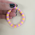 Load image into Gallery viewer, Purple and orange bracelet.
