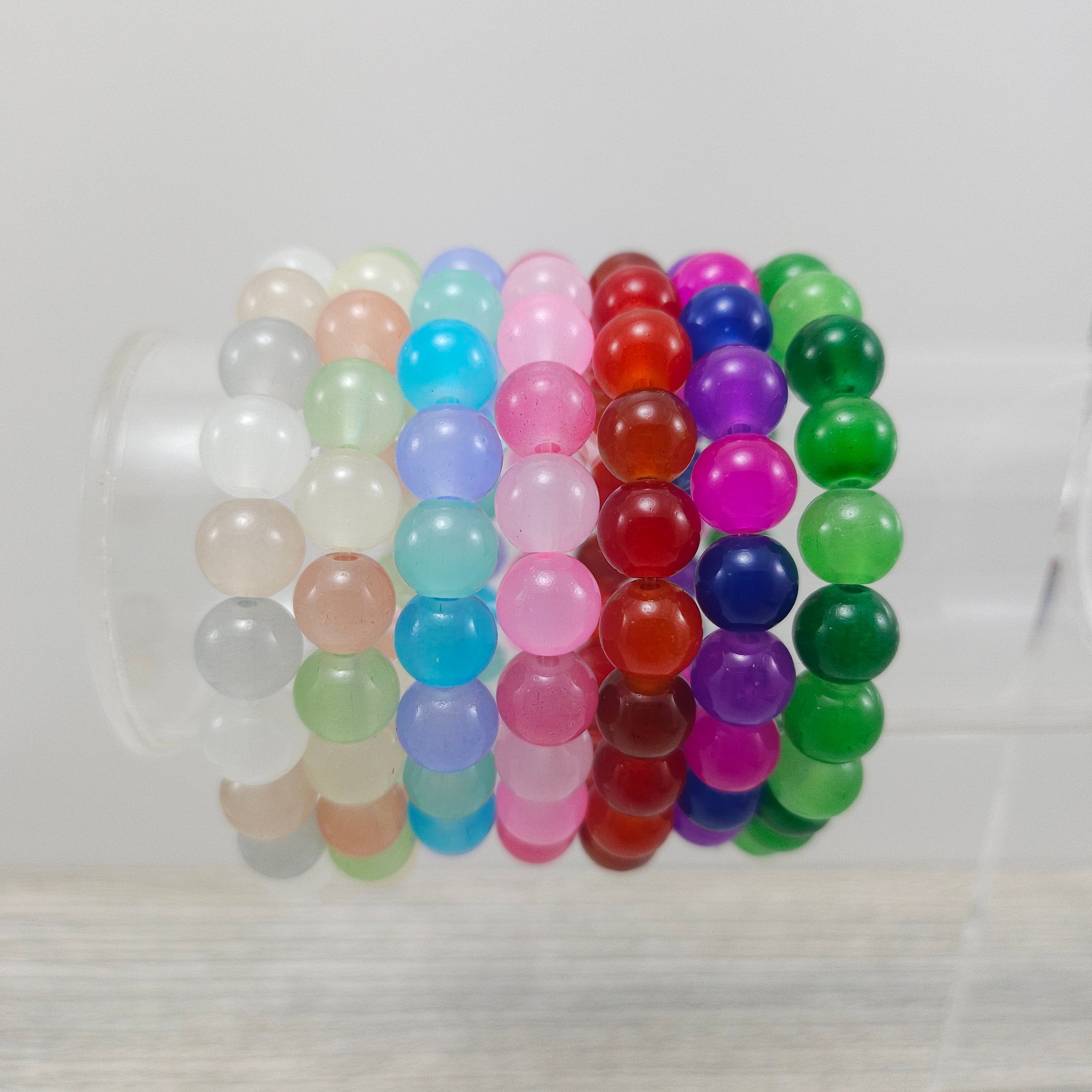 Glass bead stretch bracelets on stand.