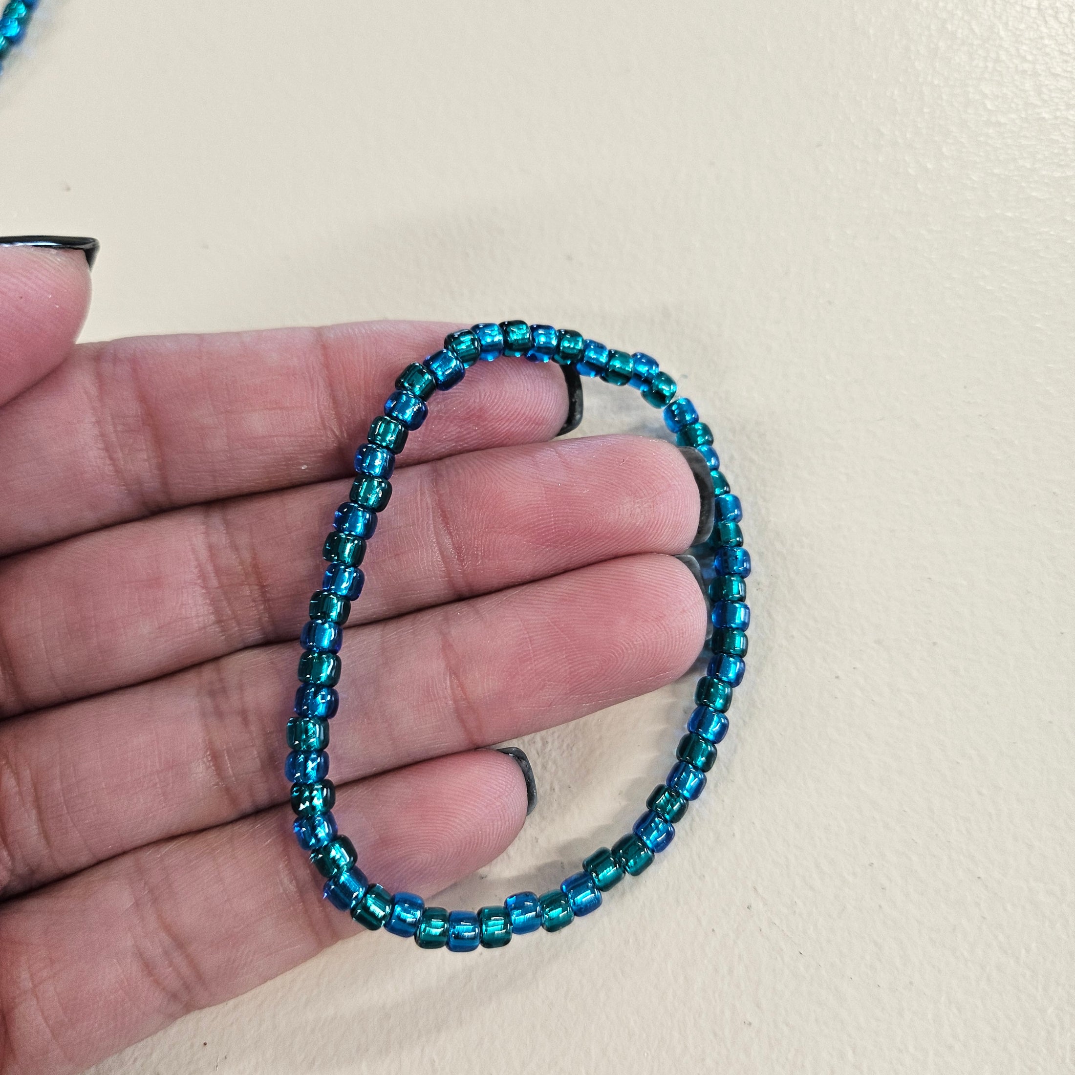 Blue and green beaded stretchy bracelet. 