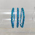 Load image into Gallery viewer, Ocean blue stretch bracelets on stand.
