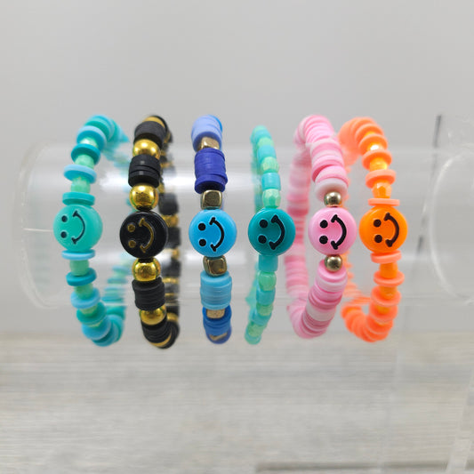 Smiley face stretch bracelets on rack.