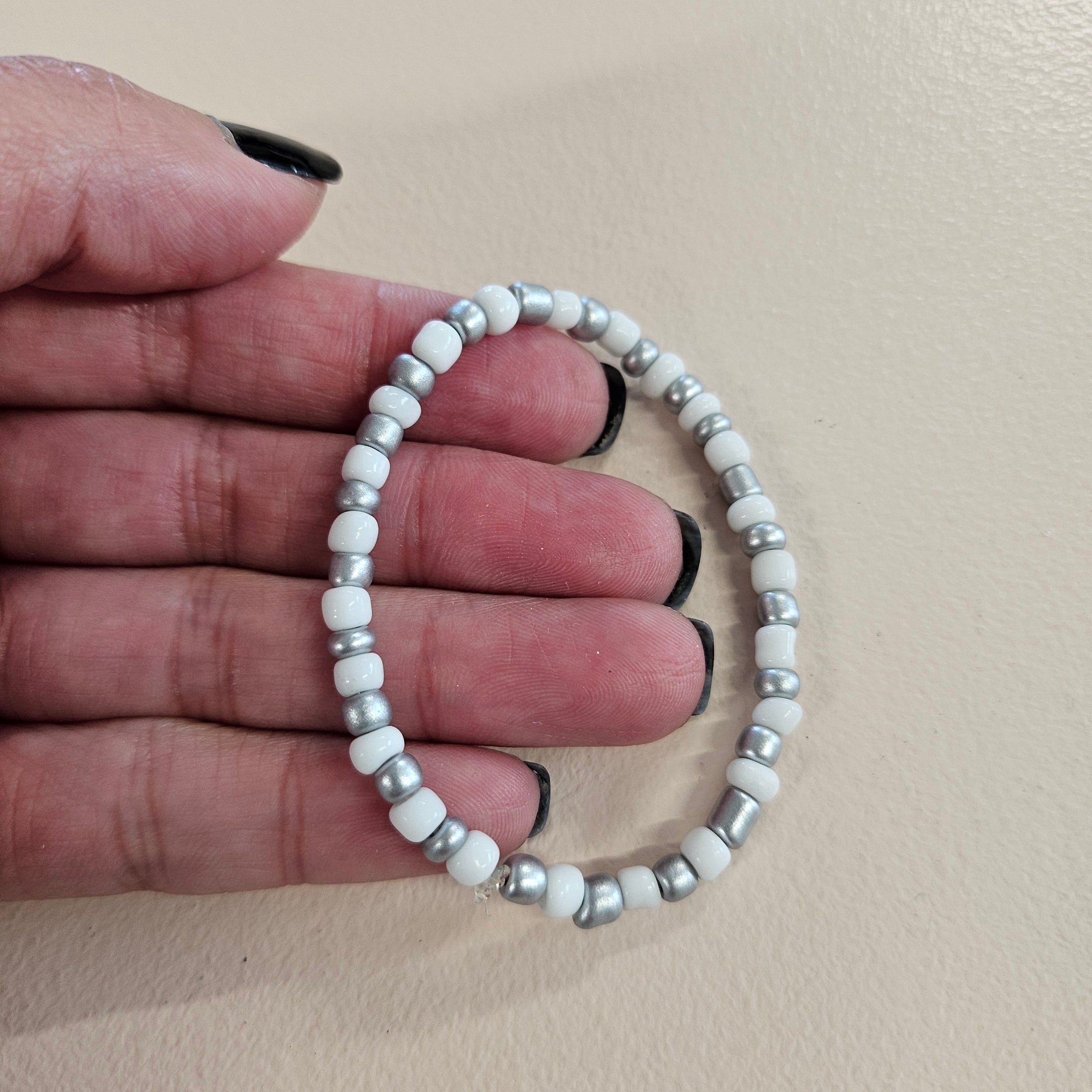 White and silver metallic stretch bracelet.