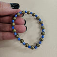 Load image into Gallery viewer, Blue and gold metallic stretch bracelet.
