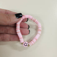 Pink smiley face friendship bracelet.