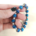 Load image into Gallery viewer, Metallic blue rainbow stretch bracelet.
