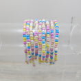 Load image into Gallery viewer, Easter themed friendship bracelets on stand. 
