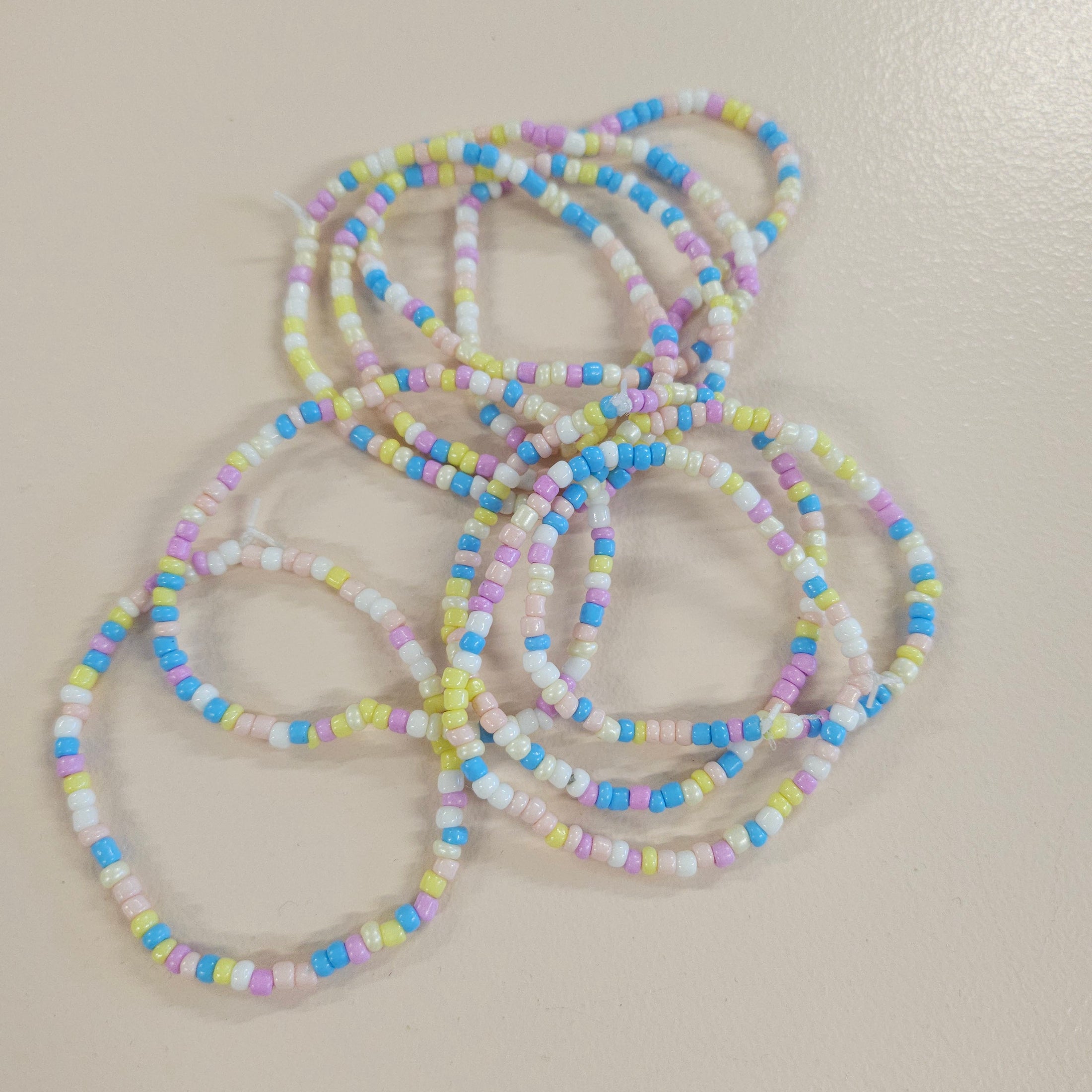 Blue, purple, white, yellow and pink beaded friendship bracelet. 