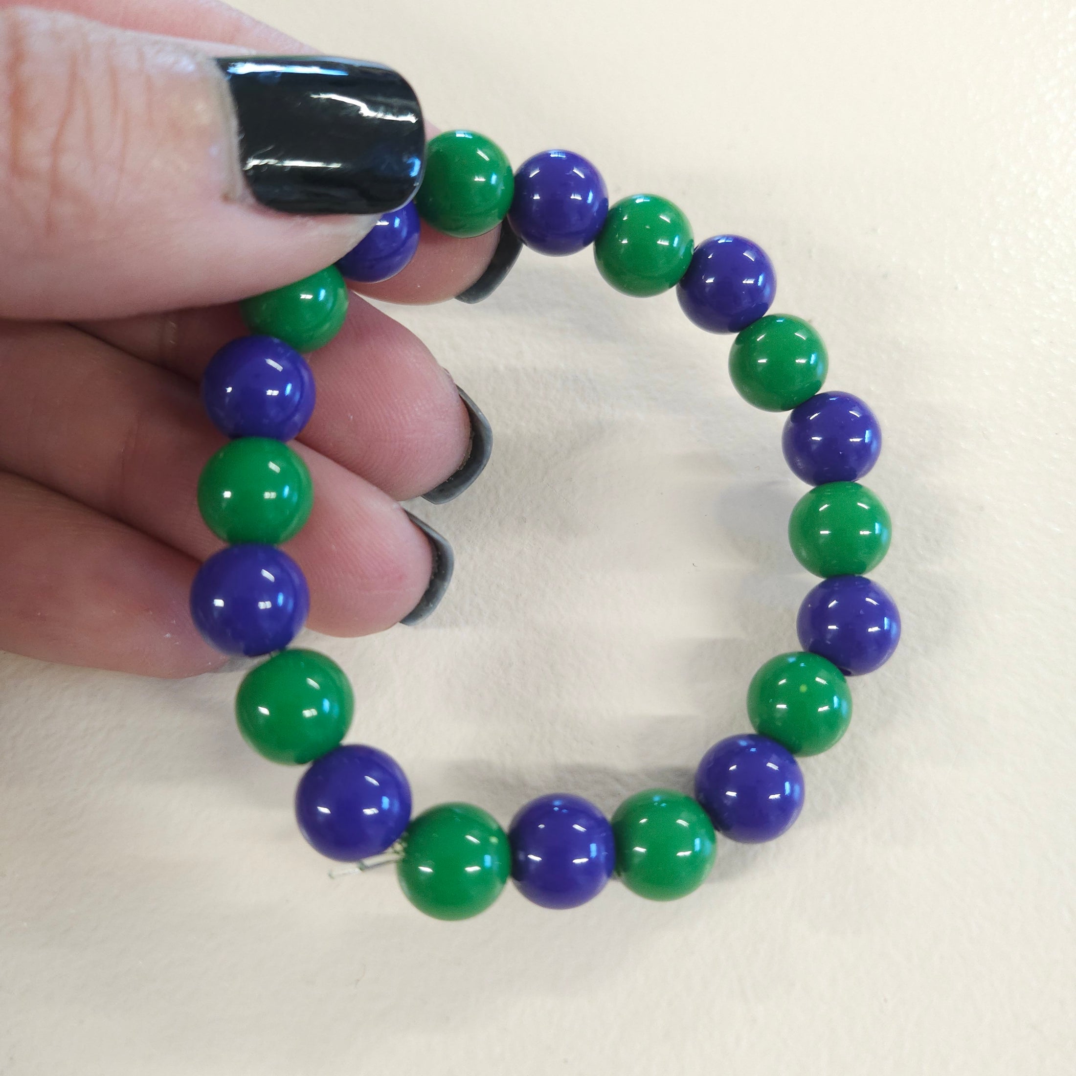 Dark blue and green gumball bead stretch bracelet.