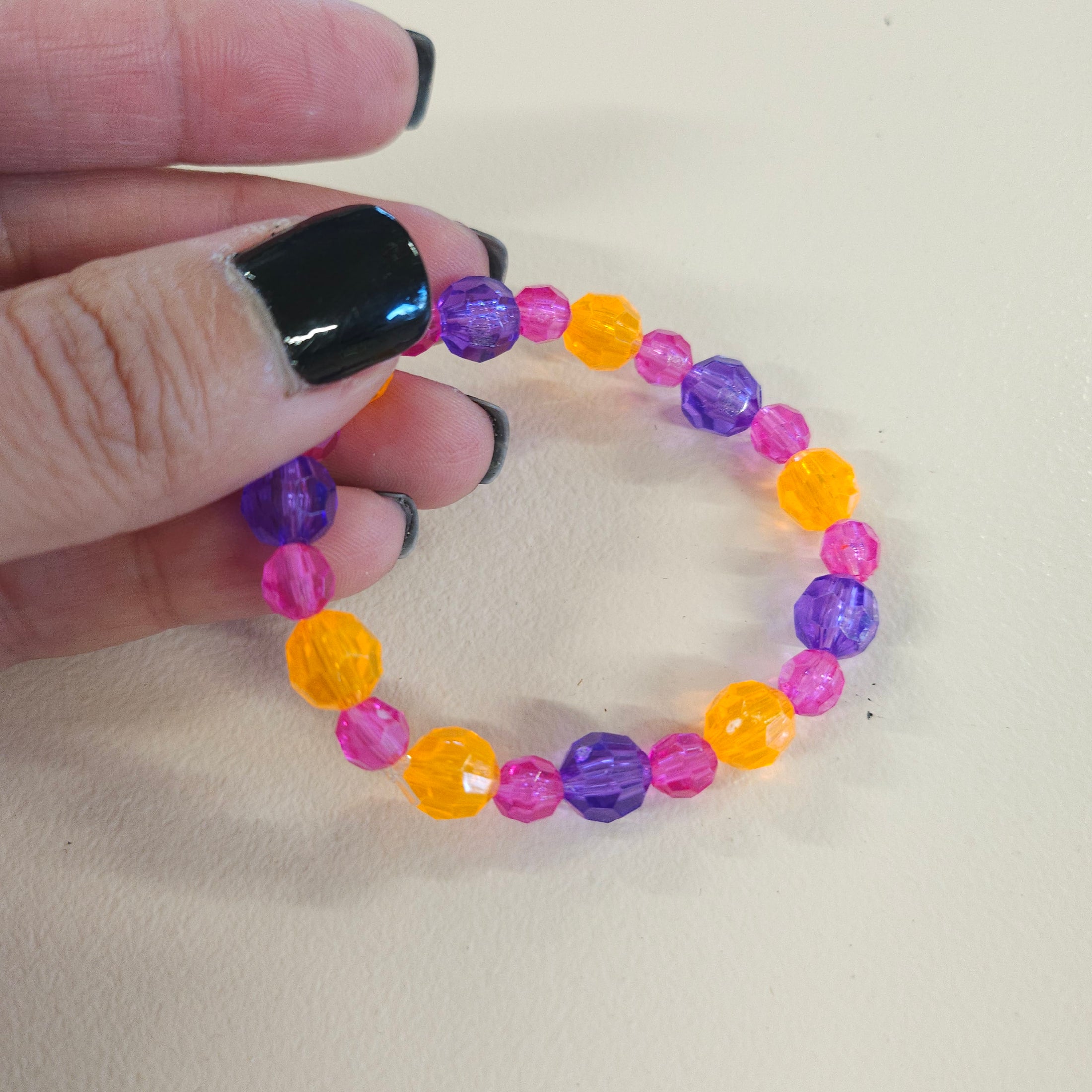 Purple, pink and orange beaded bracelet.