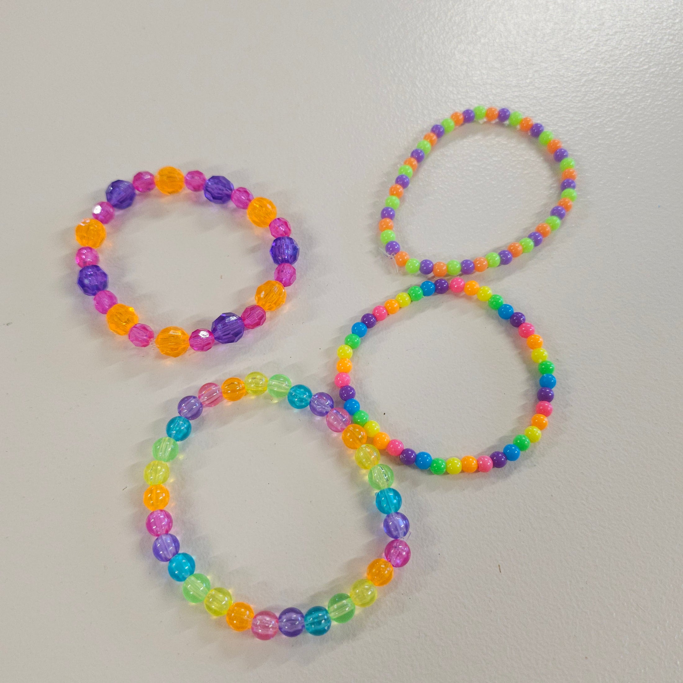 Rainbow colorful plastic bead stretch bracelets.