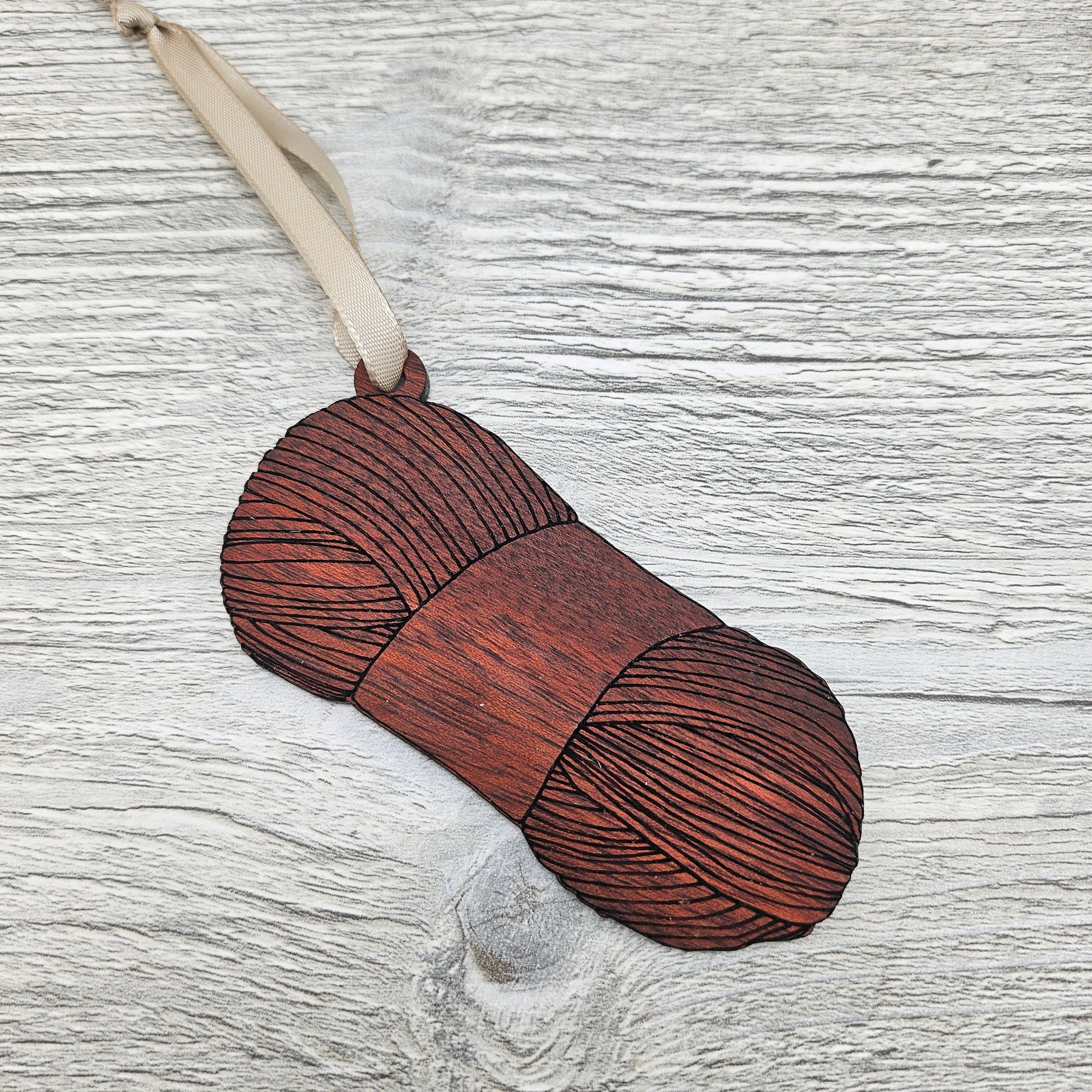 Laser cut and engraved yarn skein ornament blank made from exotic bloodwood.