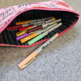 Load image into Gallery viewer, Praise be bitches zipper pouch laying on its side with markers.
